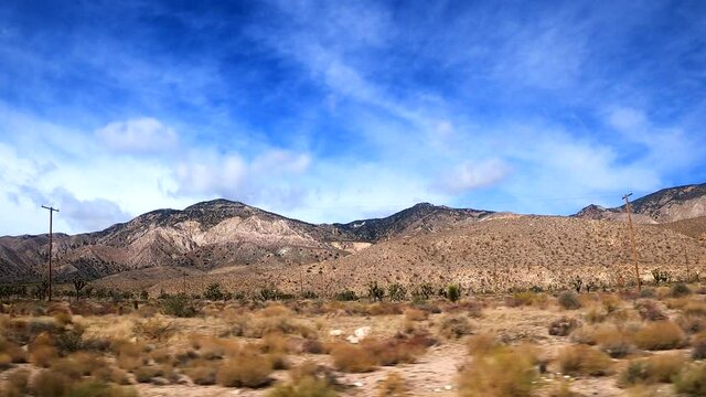 Driving through the Mojave Desert landscape while watching the scenery out the passenger window