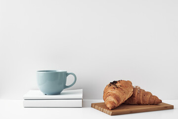 Mug and croissants on a white background. Eco-friendly and natural materials in the decor, dessert. Copy space, mock up