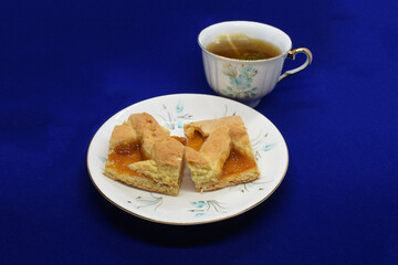 Homemade pie with orange jam and a cup of tea, sweet food