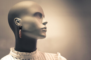 Portrait of mannequin. Woman profile face in store window. Isolated bald dummy. Shopping, beauty or feminine concept