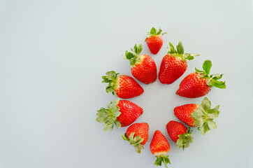 Festive blue background. Red fresh strawberries close up. Valentine's Day. Food backgrounds. Creative greeting card. Flat lay, top view.