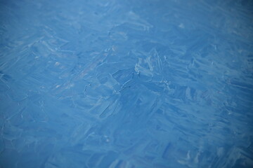 Textured dried blue oil paints. The texture of the painting. Close-up of dried oil paint patterns on an old wooden palette.