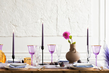 Beautiful flower composition on the wooden table. Colorful bouquet in a glass vase. The wedding decor and fruits