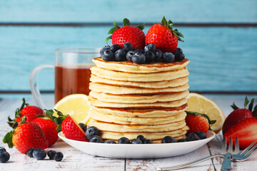 A stack if home-made pancakes with berry