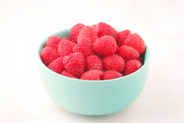 A bowl with ripe bright raspberries