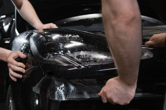 automobile detailing service. protective film on the headlight of the car.