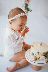 baby girl eating a cake . first cake party