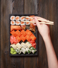asian food delicacy sushi and rolls wooden chopsticks on table