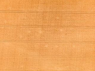 Aerial view of wheat field with tractor tracks. Farm from drone view.