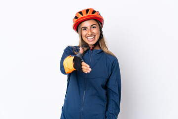 Young hispanic cyclist woman isolated on white background shaking hands for closing a good deal