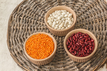 Raw red and white beans, orange  lentils  in a ceramic bowl