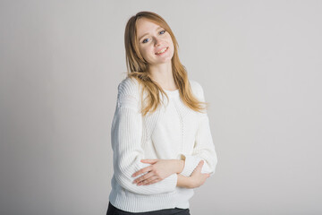 Portrait of a stylish and smiling girl on a white background in the studio