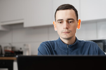 Self entrepreneur sitting and working at his modern apartment.