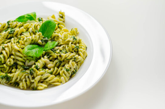 Pesto and pine nut pasta salad, fusilli pasta with regato cheese and baby spinach coated in basil pesto