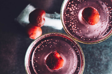 Red cherry cocktail drink  isolated on black background. Top view.