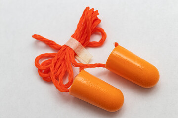 Roll-down foam earplugs on a white background