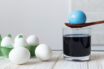 Process of dyeing boiled eggs for Easter, traditions for Easter, blue dye for eggs