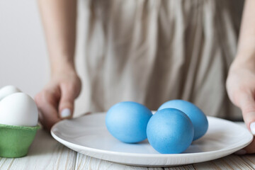 Coloring boiled eggs for Easter, traditional Easter eggs, blue eggs
