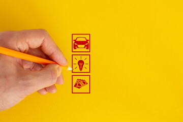 Close up of businessman hand drawing business strategy sketches. idea, car, money. Yellow background.