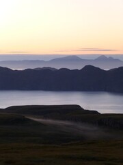 Sunset over the sound of Mull and Ardnamurchan, with Rum in the distance and mist forming in the hills 