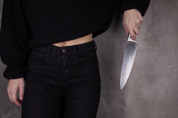 Woman hand holding big knife. Aggressive woman.