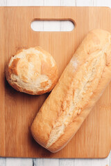 rye loaf on a wooden board top view soft bun