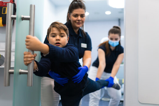Scared teenager trying to escape from the dentist's office. Fear of doctors concept