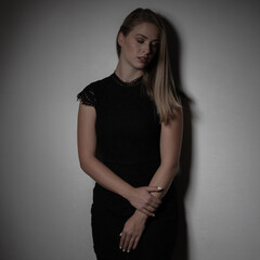 Dramatic studio portrait of beautiful young woman on dark background..