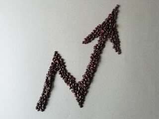 Up arrow made of roasted coffee beans