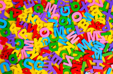 Top view colorful letters on yellow background. Education Concept