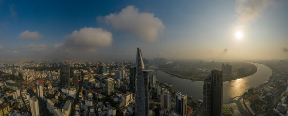Ho Chi Minh City, District One, Vietnam. Classic drone panorama of all key buildings and the Saigon River in golden light