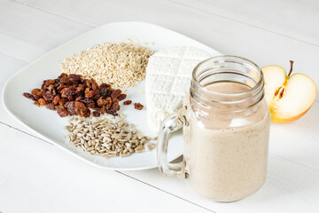 Tasty white cheese, oatmeal, raisins and sunflower seeds for a healthy breakfast cocktail smoothie