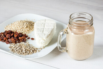 Tasty white cheese, oatmeal, raisins and sunflower seeds for a healthy breakfast cocktail smoothie