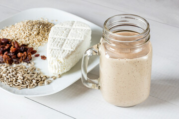 Tasty white cheese, oatmeal, raisins and sunflower seeds for a healthy breakfast cocktail smoothie