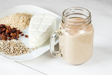 Tasty white cheese, oatmeal, raisins and sunflower seeds for a healthy breakfast cocktail smoothie