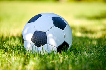 close-up view of leather soccer ball on green grass