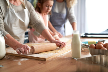 Obraz na płótnie Canvas Close up of women rolling dough