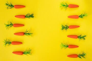 Fototapeta na wymiar Easter pattern made with carrots on bright yellow background. Easter holiday concept. Flat lay.