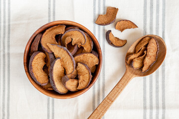 Slices of sun dried fruits dehydrated apples on white background.