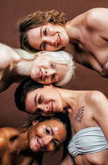 Group of multiethnic women with different kind of skin posing together in studio. Concept about body positivity and self acceptance