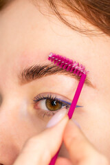 Young Caucasian Woman on the brow beauty procedures. Professional care for face. Brows coloring,...
