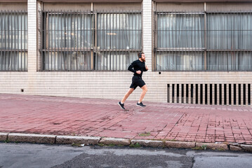 Young Man Running in the Street