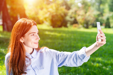 Young redhead woman taking selfie photo
