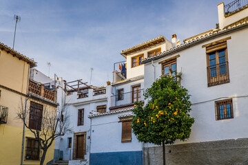 Fototapeta na wymiar the narrow streets and white facades typical of the Albaicin historic district in Granada, Andalusia, Spain