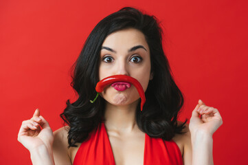 Image of beautiful woman having fun with a red chili pepper