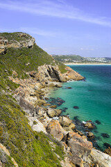 View of mountains, rocks and the sea with crystal clear water. Robber Nature Reserve, Plettenberg Bay, South Africa.