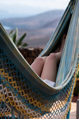 girl enjoying summer time in a hammock