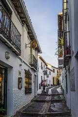 the narrow streets and white facades typical of the Albaicin historic district in Granada, Andalusia, Spain