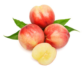 Heap of whole peaches and slices with leaves isolated on white background
