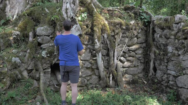 Male model in archaeologic site, huari culture, ruins in middle of the jungle, peruvian culture